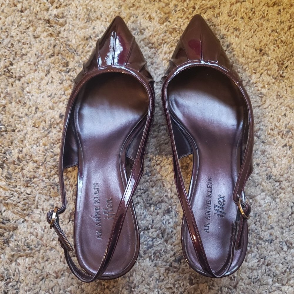 Cranberry patent sling back with a pointed toe and kitten heel